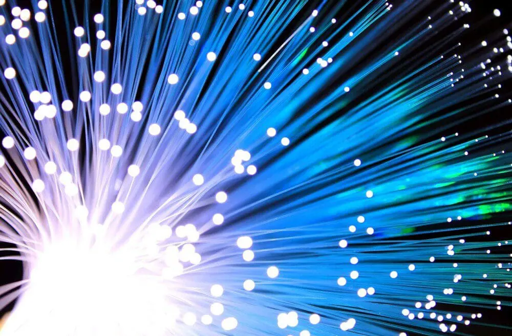 right burst of light with blue and white fiber optic strands representing the future of AI, high-speed data transmission, AI-driven technology advancements, and the potential of artificial intelligence in innovation and automation.