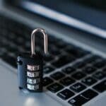 An open padlock on a laptop keyboard, representing online privacy, cybersecurity, and securing personal data